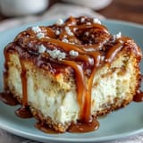 A close-up of caramel cream cheese bread shows a generous swirl of caramel and a tender, moist slice ready to enjoy.  