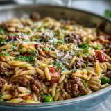 Savory Comforting Ground Beef Orzo simmered with bell peppers and peas in a rich tomato broth.