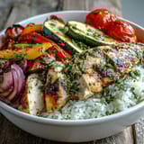 A hearty, wholesome bowl featuring perfectly cooked Lemon Herb Roasted Chicken, colorful roasted vegetables, and fluffy rice, ready to be enjoyed for a healthy weeknight dinner.