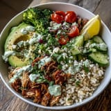 Freshly shredded rotisserie chicken, fluffy brown rice, and crisp veggies topped with creamy tzatziki and fresh herbs.