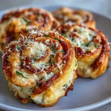 Cheesy Air Fryer Pizza Roll Ups, hot from the air fryer, ready to dip.