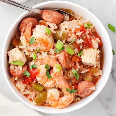 A hearty bowl of homemade jambalaya, featuring tender chicken and smoky sausage, perfect for a family-style Southern dinner.