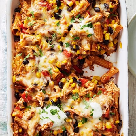 Golden, bubbly cheese tops the Chicken Burrito Pasta Bake, loaded with penne, black beans, and salsa.