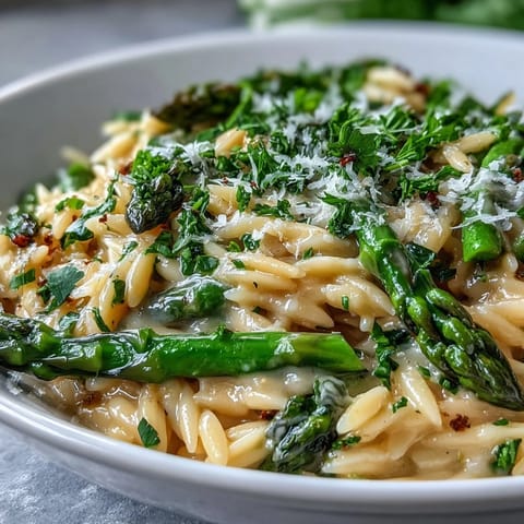 Creamy Lemon Butter Orzo and Asparagus recipe, vibrant green spears, perfect for dinner.