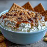Creamy cheesecake dip with graham crackers, a simple three-ingredient dessert perfect for parties and sweet cravings.