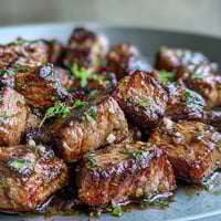 Juicy steak bites seared in garlic herb butter, bursting with savory flavor for a quick summer dinner.  