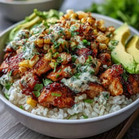 Street Corn Chicken Rice Bowls burst with vibrant toppings, smoky chicken, and creamy sauce.