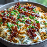 Creamy, cheesy Carbonara Buldak Ramen Bake bubbling with a golden crust.